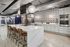 Modern kitchen with a sleek marble island, stylish geometric backsplash, and contemporary pendant lighting, perfect for entertaining.
