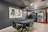 Chic lounge area with a stylish poker table, modern artwork, and convenient snack vending machines.