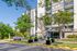 Chic urban apartment complex with modern balconies, lush landscaping, and welcoming entrance in a vibrant setting.