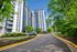 Inviting residential complex with modern high-rise buildings surrounded by lush greenery, offering a serene living environment.