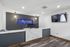 Modern reception area with elegant marble desk, dual monitors, and a chic wall display showcasing the Arrive 2801 sign.