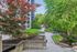 Charming urban courtyard featuring lush green landscaping and mature trees, offering a serene retreat in a vibrant setting.