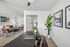 Contemporary apartment interior featuring a stylish open-concept living room with modern furnishings, lush greenery, and elegant artwork.