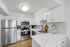 Sleek modern kitchen with stainless steel appliances, bright white cabinetry, and elegant subway tile backsplash.