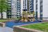 Charming residential complex boasting a vibrant playground surrounded by lush greenery and modern architecture.