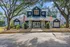 Charming leasing center with classic architecture surrounded by lush greenery and mature trees, offering a warm welcome to prospective residents.