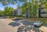 Charming apartment complex surrounded by lush greenery and featuring abundant natural light, with convenient parking and a welcoming atmosphere.