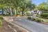 Charming apartment complex surrounded by lush greenery and trees, offering a serene and welcoming environment.