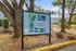 Inviting outdoor sign displaying 'The Social Seminole' layout surrounded by lush greenery, highlighting a vibrant community in Tallahassee, Florida.