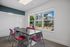 Bright and airy meeting room with modern decor and large window overlooking a landscaped courtyard.