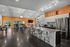 Modern communal space in Edwardsville featuring an open kitchen with large island seating, sleek stainless steel appliances, and stylish contemporary design.