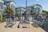 Contemporary apartment complex with inviting outdoor seating and a fenced pool area, perfect for relaxation and leisure.