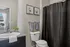 Elegant bathroom featuring a sleek granite countertop, modern fixtures, and stylish decor with natural light streaming in.