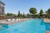 Luxurious outdoor pool area with sleek loungers and shaded cabanas, perfect for relaxation and enjoyment.