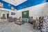 Chic and inviting communal lounge with stylish patterned chairs, a plush sofa, and modern decor against a white brick wall, ideal for socializing and relaxation.
