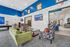 Modern community lounge with vibrant decor, plush seating, and entertainment options, including a pool table and arcade game.