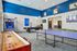 Inviting recreation room featuring a ping pong table, dartboard, basketball arcade game, and a stylish billiards table with vibrant decor.