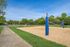 Inviting outdoor sand volleyball court set against lush greenery, perfect for recreation and relaxation.