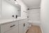 Contemporary bathroom with sleek white cabinetry, elegant fixtures, and a spacious bathtub, ideal for modernization enthusiasts.