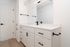 Modern bathroom with sleek white cabinetry, stylish black hardware, and elegant countertops for a contemporary feel.