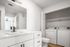Modern bathroom with sleek vanity, integrated laundry area, and pristine white finishes for a convenient and stylish home experience.
