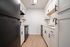 Modern kitchen with sleek black appliances, white cabinetry, and elegant wood flooring for a stylish look.