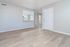 Inviting apartment interior with elegant wood flooring, bright walls, a compact kitchen, and an open layout perfect for modern living.