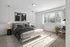 Modern bedroom with chic grey bed, stylish artwork, and large window offering natural light and serene garden views.