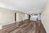 Modern open-concept living area with elegant hardwood floors, sleek kitchen island, and contemporary stainless steel appliances.