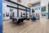 Bright and modern game room with a sleek pool table, vibrant blue chairs, and a stylish bar area featuring yellow stools.