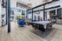 Chic modern lounge area with a pool table, stylish seating, and open-concept kitchen featuring stainless steel appliances.