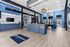 Modern office lobby with stylish decor, vibrant blue accents, and ample natural light. Features contemporary lighting and welcoming reception area.