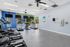 Modern fitness center with state-of-the-art exercise equipment and pool view, perfect for an active lifestyle.