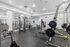 Modern fitness center with a range of high-end exercise equipment, including weight machines and cardio stations, in a bright and spacious setting.