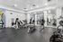 Modern and spacious fitness center featuring state-of-the-art gym equipment and mirrored walls ideal for an invigorating workout experience.