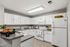 Bright, modern kitchen with sleek white cabinetry, spacious countertops, and inviting decor.