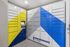 Modern package locker room with vibrant blue and yellow geometric design at townhomes, featuring digital screen for secure access.