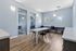 Modern study room with elegant black chairs, sleek white tables, and natural light from large windows.