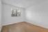 Bright and inviting room with natural light, featuring elegant wooden flooring and a serene view through the window.