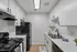 Modern kitchen featuring sleek black appliances, elegant white cabinetry, and polished countertops with a stylish design.