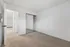 Bright bedroom with plush carpet and mirrored closet doors, offering a spacious and inviting atmosphere.