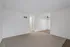Bright and inviting room with fresh white walls, cozy carpet, and stylish ceiling fan.