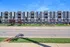 Modern apartment complex with sleek architecture and inviting balconies, located in a vibrant neighborhood with lush greenery.