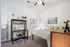 Elegant bedroom with modern decor, cozy bed, chic desk setup, and tasteful wall art, creating a serene atmosphere.