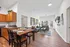 Bright and modern open-plan apartment featuring a cozy living room, stylish dining area, and sleek kitchen with elegant wood cabinetry.