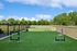 Expansive dog park with agility equipment and lush green surroundings, perfect for pet-friendly apartments.