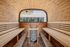 Inviting wooden sauna with cozy bench seating and a modern heating element, perfect for relaxation.