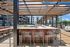 Chic outdoor living space with stylish pergola, comfortable seating, and modern grill in a vibrant apartment community.