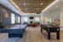 Modern entertainment area featuring a pool table, foosball, and a cozy seating lounge with a fireplace and TV, ideal for social gatherings.