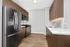 Modern kitchen with sleek stainless steel appliances, elegant wood cabinetry, and polished countertops.